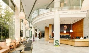 a lobby of a building with chairs and a counter at Sercotel Sorolla Palace in Valencia