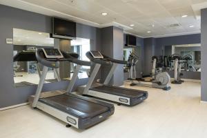 a gym with several treadmills and elliptical machines at Sercotel Sorolla Palace in Valencia