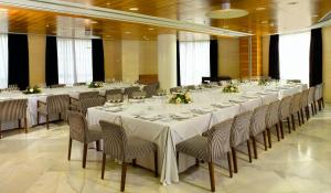 a large room with a long table and chairs at Sercotel Sorolla Palace in Valencia