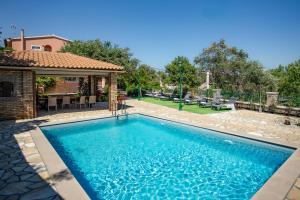 a swimming pool in a yard with a house at Villa Marifei in Kato Korakiana