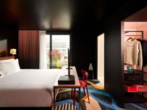 a bedroom with a bed and a table and a chair at Mama Shelter Paris East in Paris +201 photos