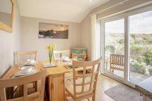 a dining room with a table and chairs and a window at 2 Bed in Mumbles oc-hh505 in The Mumbles