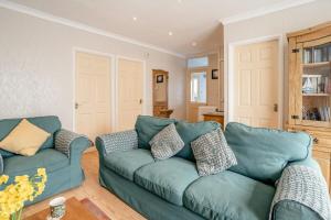a living room with a green couch and a table at 2 Bed in Mumbles oc-hh505 in The Mumbles