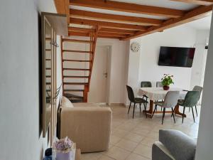 a living room with a table and chairs at Apartment Lighthouse n3 in Fažana