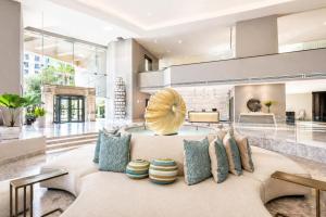 a living room with a couch with pillows at Hyatt Regency Merida in Mérida