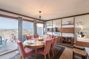 a dining room with a table and chairs and a large window at 3823 Sand Dollar House in Moss Landing
