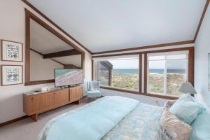 a bedroom with a large bed and a large window at 3823 Sand Dollar House in Moss Landing