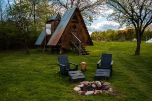 a cabin with chairs and a fire place in the grass at Gatherwild Ranch in Germantown +63 photos