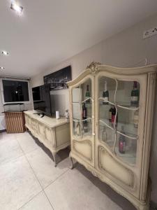 a room with a cabinet with wine bottles in it at DiDo Diamond Hotel in Dietzenbach