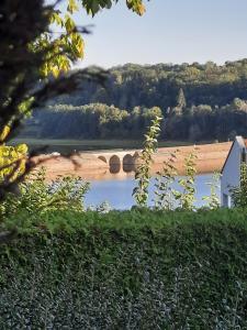 a view of a river with a bridge in the background at Gîte chez Kus in Changey