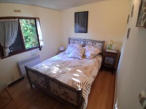 a bedroom with a bed in a room with a window at Gîte chez Kus in Changey