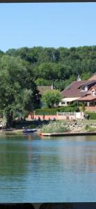 a view of a river with houses and trees at Gîte chez Kus in Changey