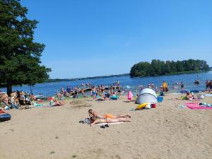 a large group of people on a beach at Leśny Zakątek - Mazury - Warmia - jezioro Dadaj in Ramsowo