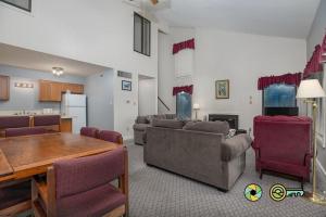 a living room with couches and a table and a kitchen at Senedo Springs Duplex #90B in Basye