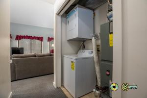 a room with a refrigerator in a room with a couch at Senedo Springs Duplex #90B in Basye