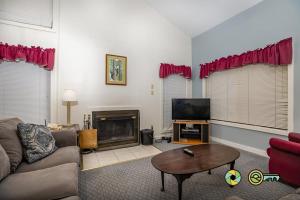 a living room with a couch and a tv at Senedo Springs Duplex #90B in Basye