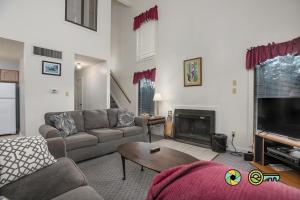 a living room with a couch and a fireplace at Senedo Springs Duplex #90B in Basye