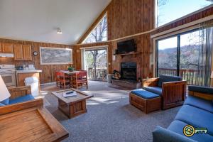 a living room with a blue couch and a fireplace at Villa #8 in Basye