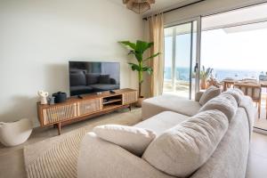 a living room with two couches and a television at Bayview Hills Apartamento Andaluz in Torrox