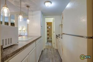 a kitchen with white cabinets and a refrigerator at Aspen East Unit #122 in Basye