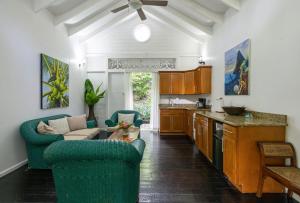 a kitchen with two chairs and a living room at Fond Doux Eco Resort in Soufrière