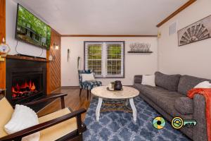 a living room with a couch and a fireplace at Lakeview 10B: Forest Den in Basye