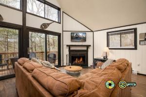 a living room with a large couch and a fireplace at 16 Deloris Road: Coppertop Chalet in Basye
