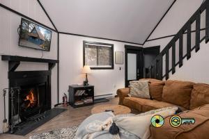 a living room with a couch and a fireplace at 16 Deloris Road: Coppertop Chalet in Basye