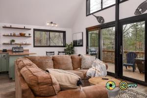a living room with a couch and a table at 16 Deloris Road: Coppertop Chalet in Basye +27 photos
