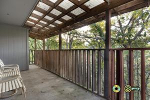 a screened in porch with a bench on a deck at Senedo Springs Condo #2-301 in Basye