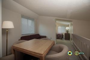a living room with a wooden table and chairs at Senedo Springs Condo #2-301 in Basye