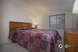a bedroom with a bed and a dresser and a window at Senedo Springs Condo #2-301 in Basye +21 photos