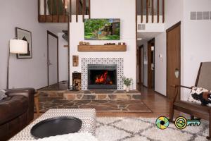 a living room with a fireplace and a couch at The Hill T-19: Eagle's Nest in Basye