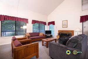 a living room with two couches and a fireplace at Senedo Springs Duplex #90A in Basye