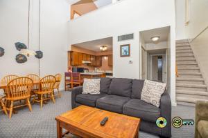 a living room with a couch and a table at Senedo Springs Duplex #98A in Basye