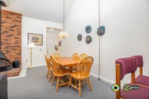 a dining room with a wooden table and chairs at Senedo Springs Duplex #98A in Basye