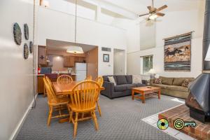 a dining room and living room with a table and chairs at Senedo Springs Duplex #98A in Basye