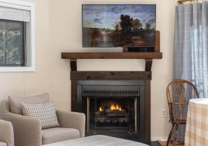 a living room with a fireplace with a tv above it at 210 Nelson Way: Par Pine Lodge in Basye