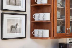 a wall with pictures of a horse and mugs at 210 Nelson Way: Par Pine Lodge in Basye +41 photos