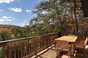 a wooden deck with a wooden table and chairs at 210 Nelson Way: Par Pine Lodge in Basye