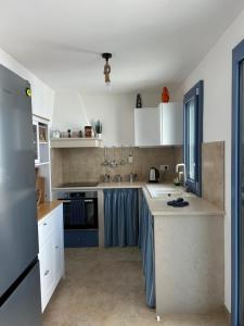 a kitchen with white cabinets and a counter top at Lamia Al Mar in Torre Canne