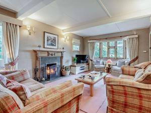 a living room with two couches and a fireplace at 4 Bed in Ringwood oc-92557 in Burley