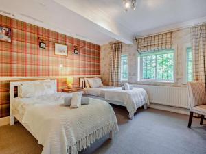 a bedroom with two beds and a window at 4 Bed in Ringwood oc-92557 in Burley
