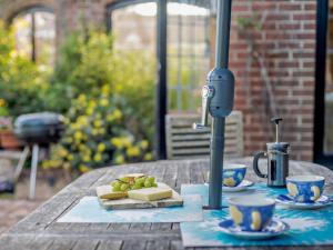 a table with food and cups on a table at 4 Bed in Ringwood oc-92557 in Burley
