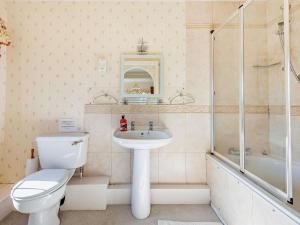 a bathroom with a toilet and a sink and a shower at 4 Bed in Ringwood oc-92557 in Burley +15 photos