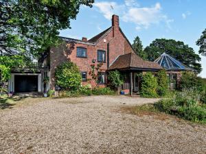 an exterior view of a brick house with a driveway at 4 Bed in Ringwood oc-92557 in Burley