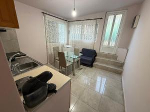 a kitchen and living room with a table and a sink at Verga Olive Grove Studio in Kalamata