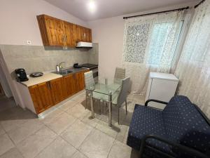 a kitchen with a glass table and a sink at Verga Olive Grove Studio in Kalamata