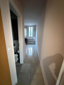 a hallway leading to a living room with aoice at Verga Olive Grove Studio in Kalamata +2 photos