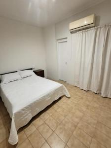 a bedroom with a white bed and a window at Departamento Abu Dolly in La Plata